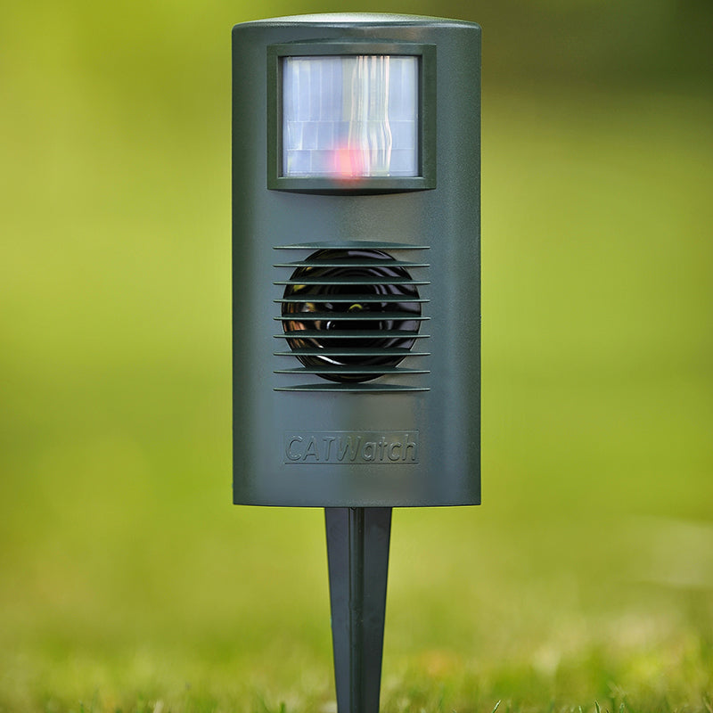 Catwatch repeller device with stake pushed into the ground
