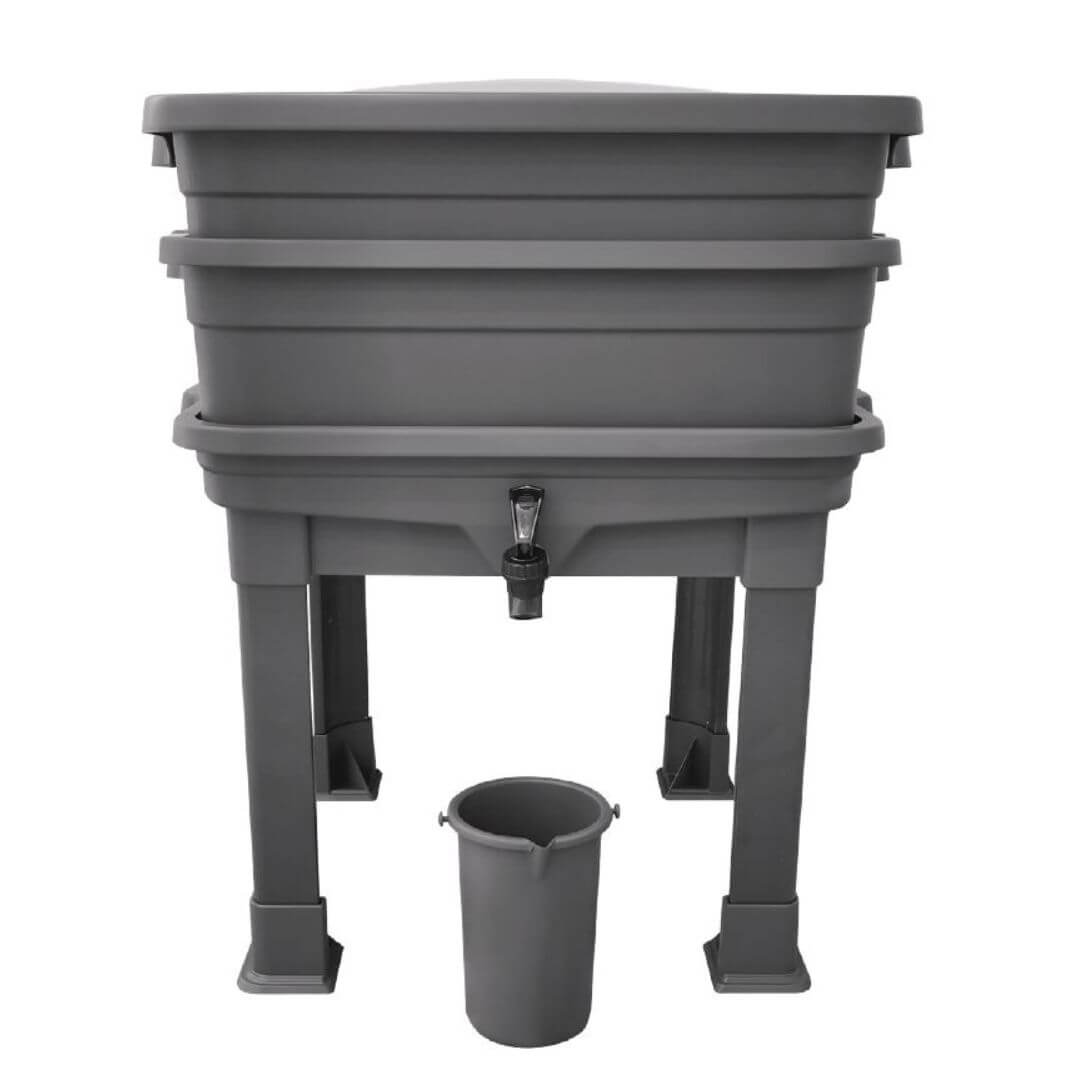 Gray plastic wormery with stand and attached bucket on a white background