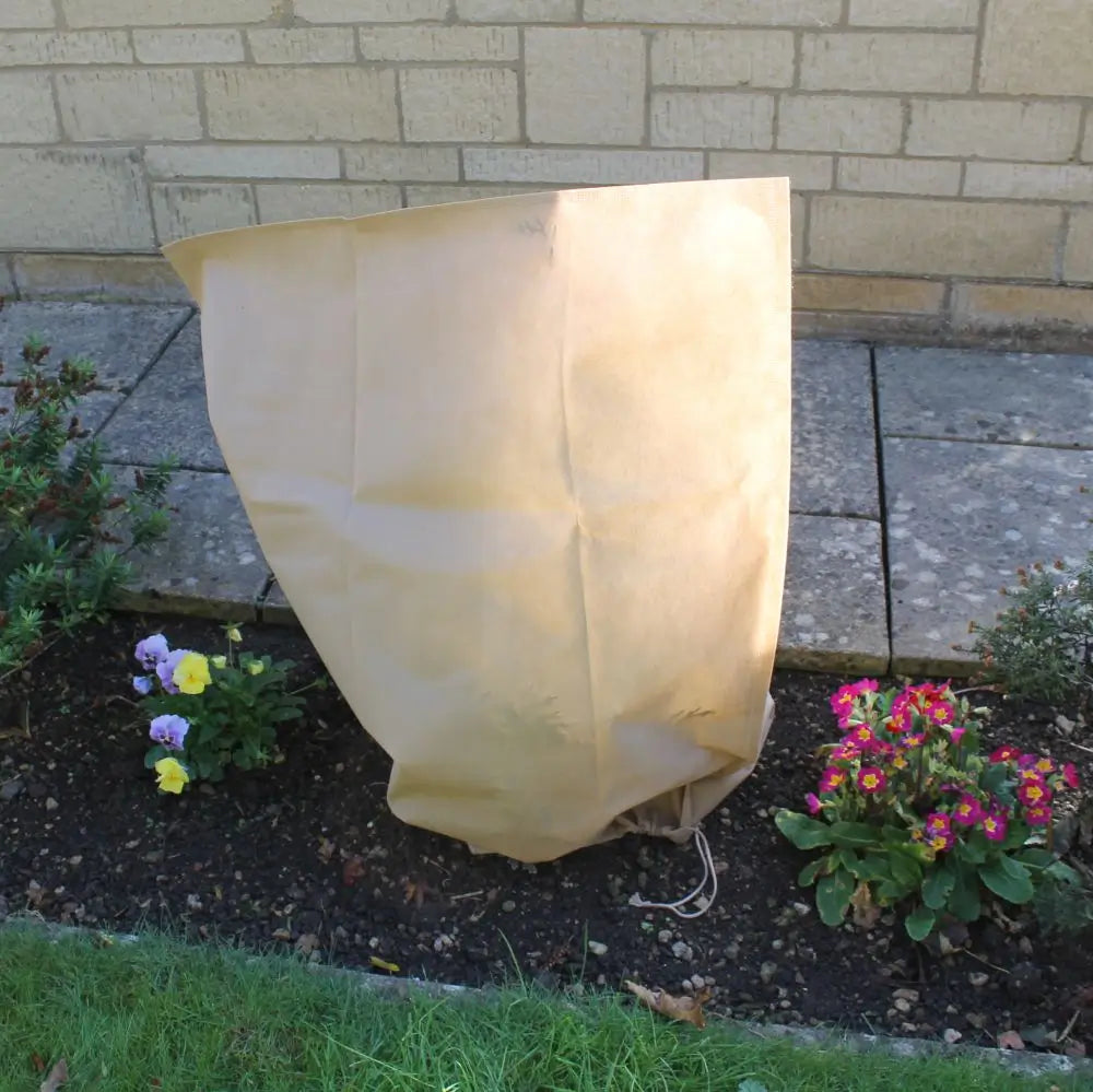 cream fleece bag in flower border