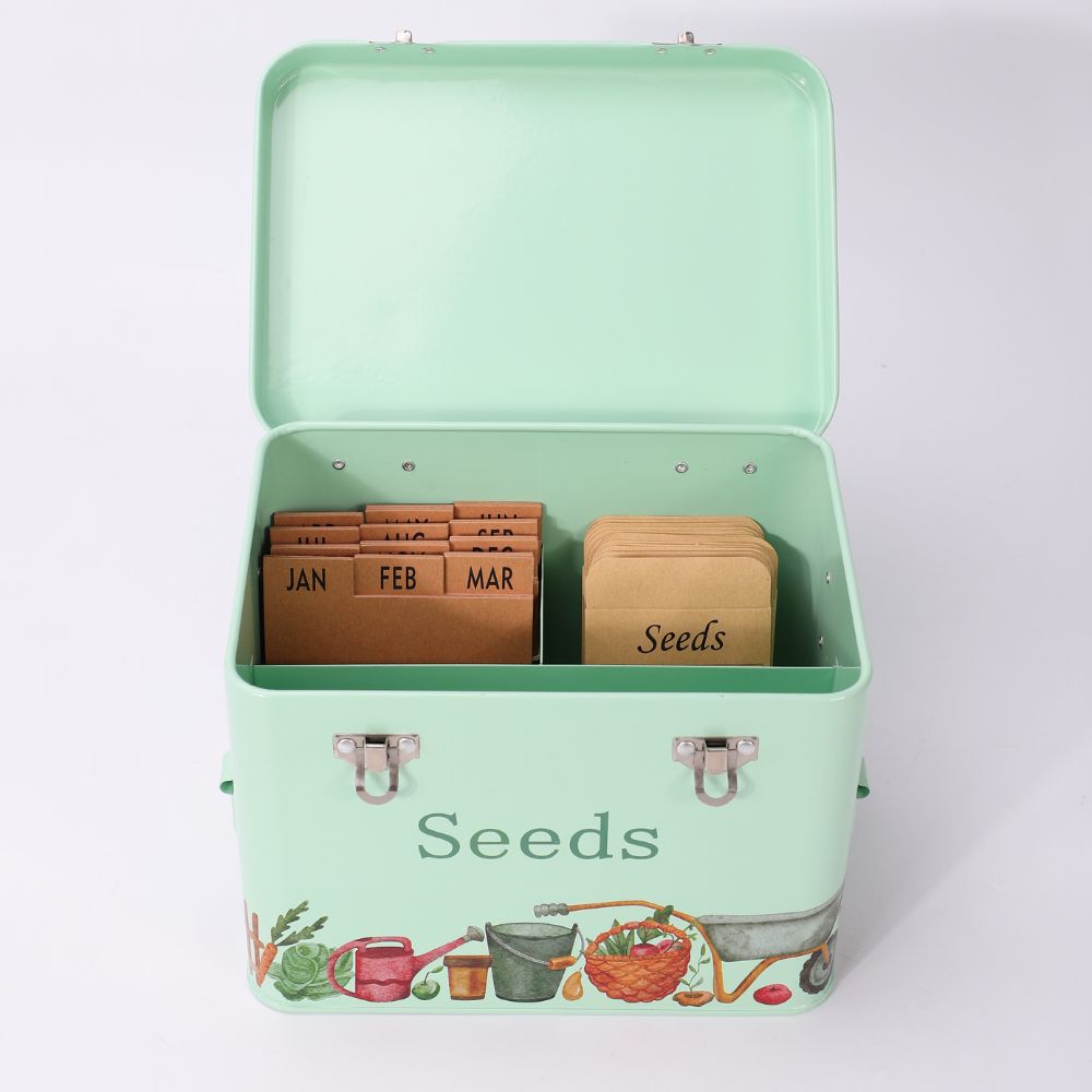 Mint green seed storage box with compartments labeled for months and 'Seeds'.