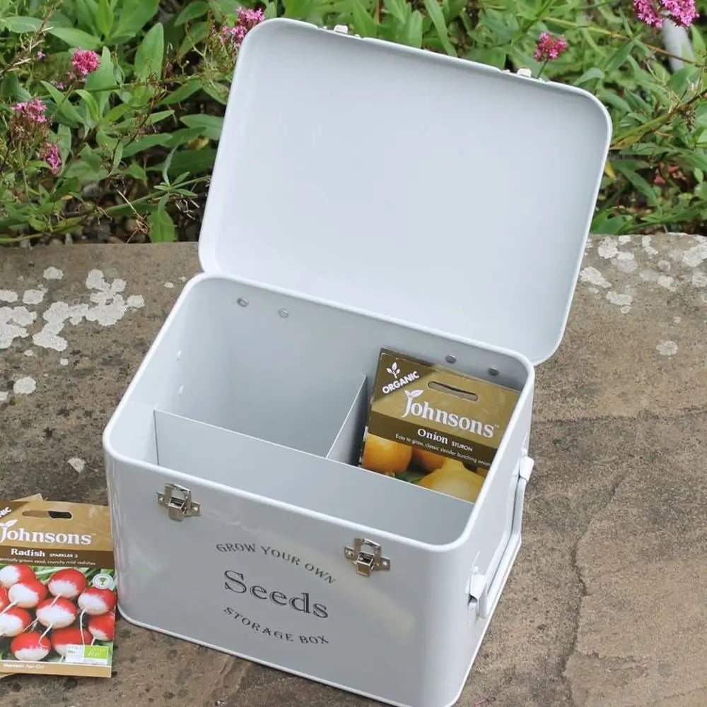 grey seed storage tin on wall with seed packets