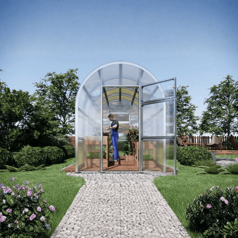 a man inside a large polytunnel greenhouse doing his gardening