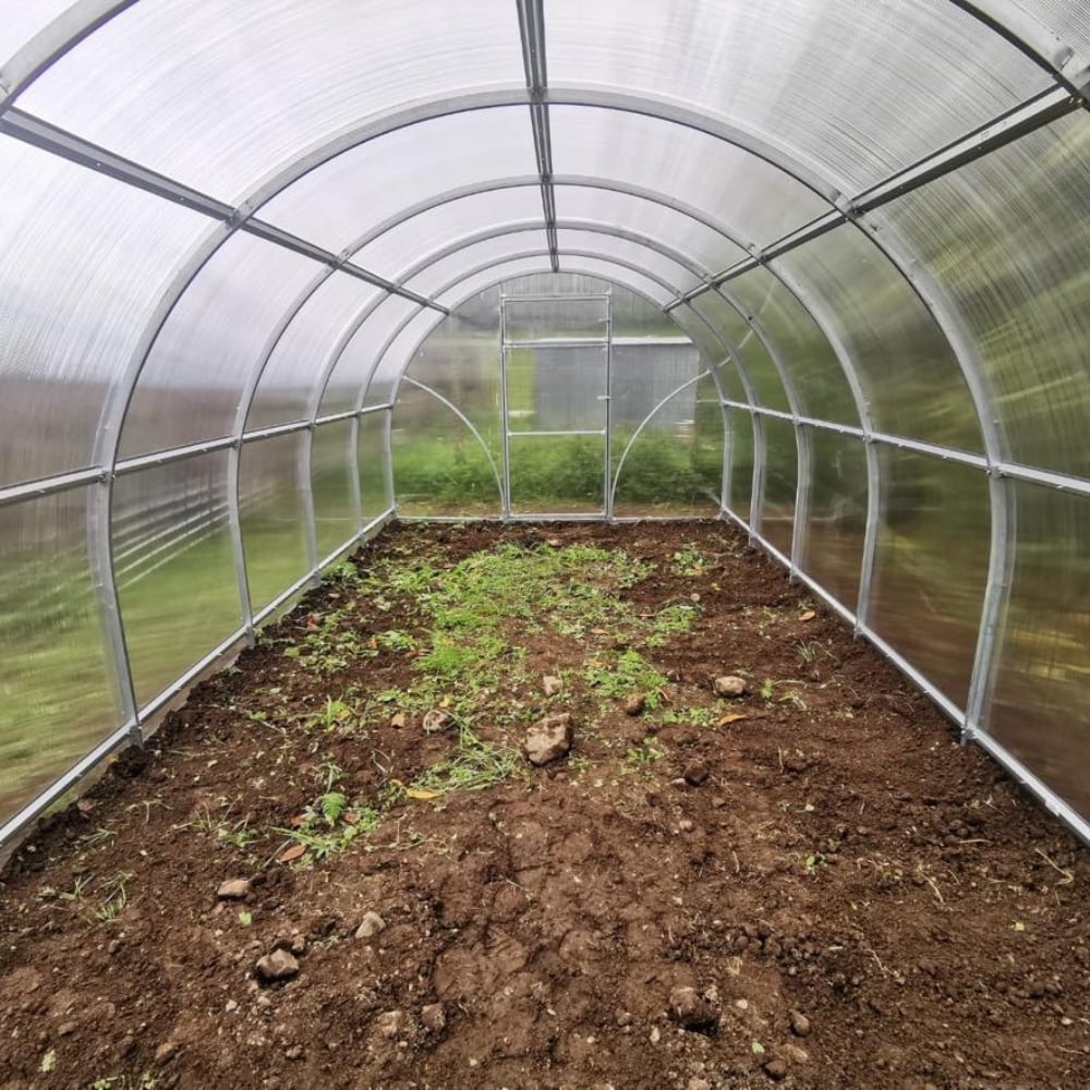 inside of greenhouse polytunnel with soil