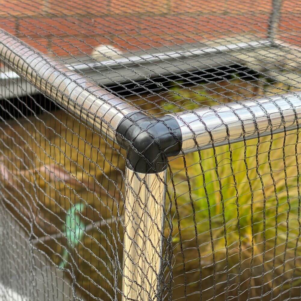 Pond cage corner showing aluminium connector and netting