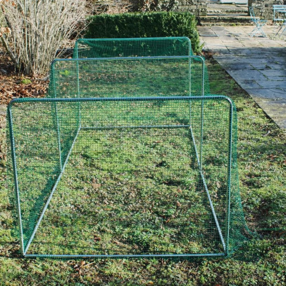 Green garden cage with green netting on grass with a garden background