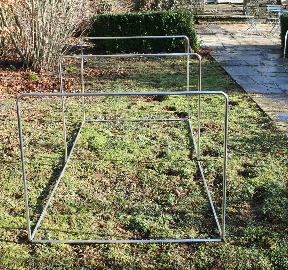 Metal garden frame on grass with outdoor setting