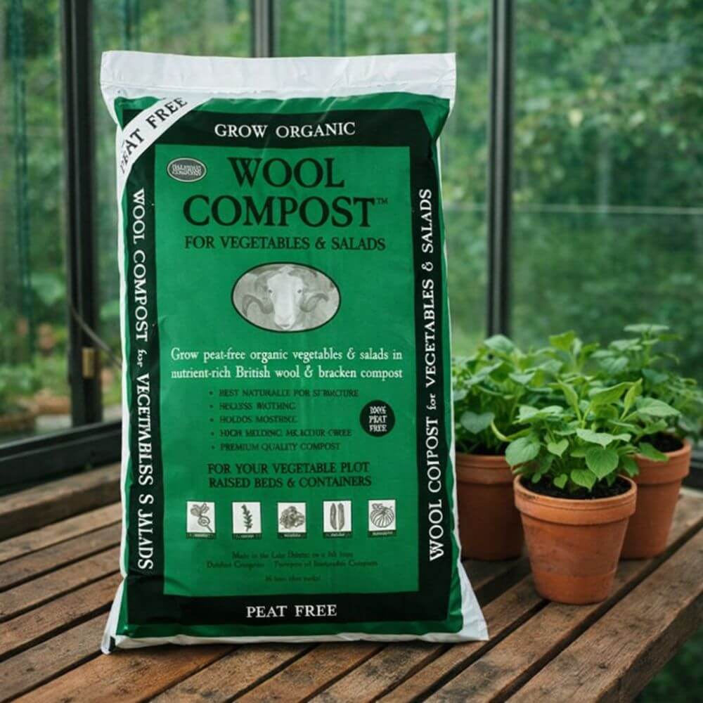 Bag of Wool Compost on a wooden surface with potted plants in the background