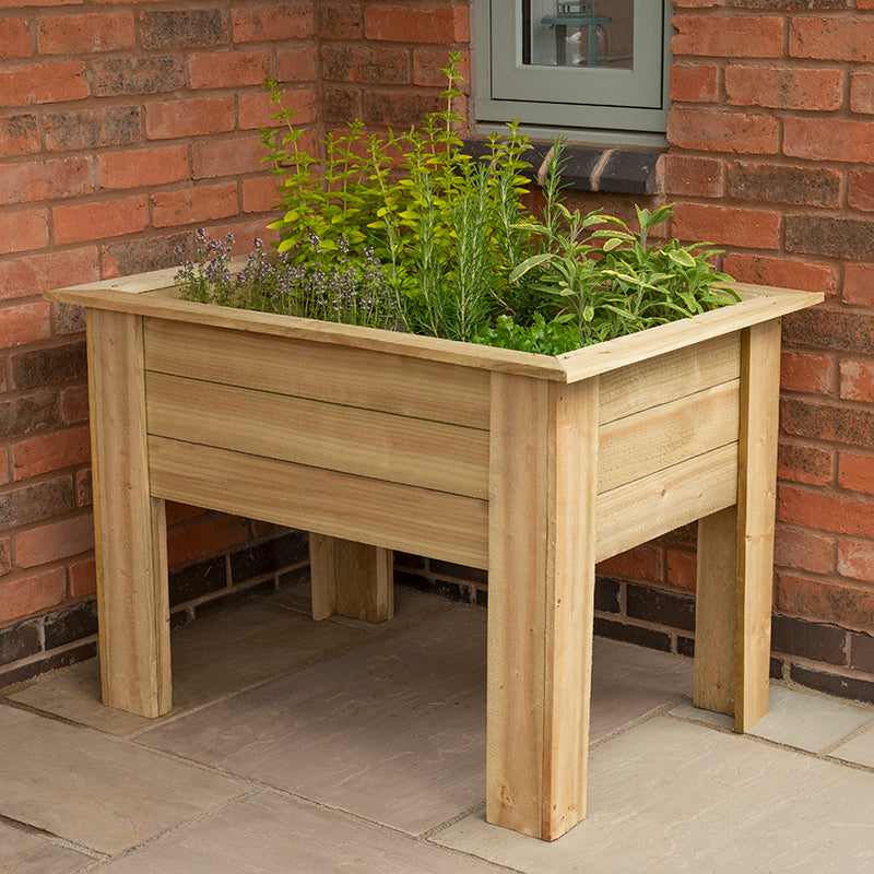 wooden kitchen planter by a red brick wall