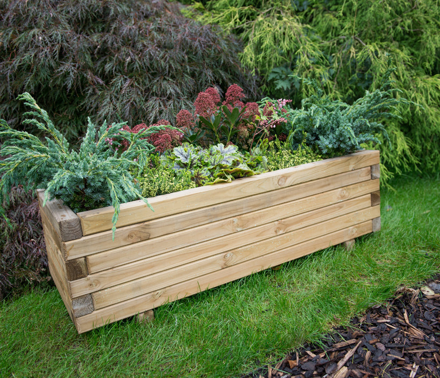 wooden planter in the garden on grass