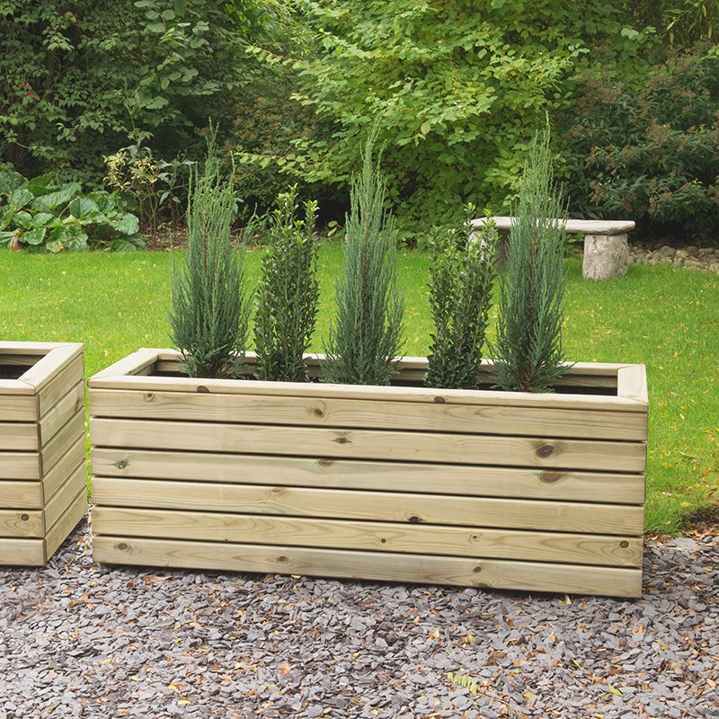 wooden planters in the garden on gravel