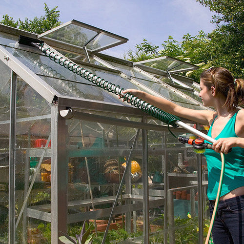 Lady cleaning greenhouse