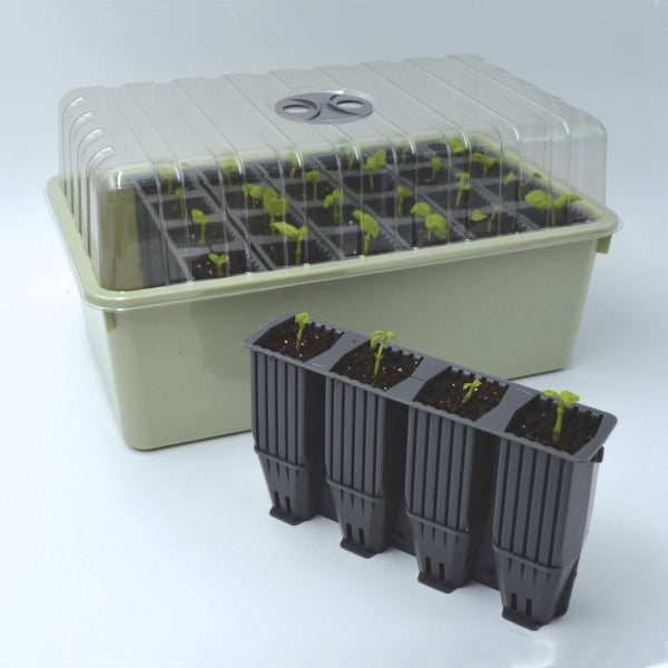 A set of black, 28-cell deep root success kit and cells, with a green base tray and a clear, ventilated cover on top.