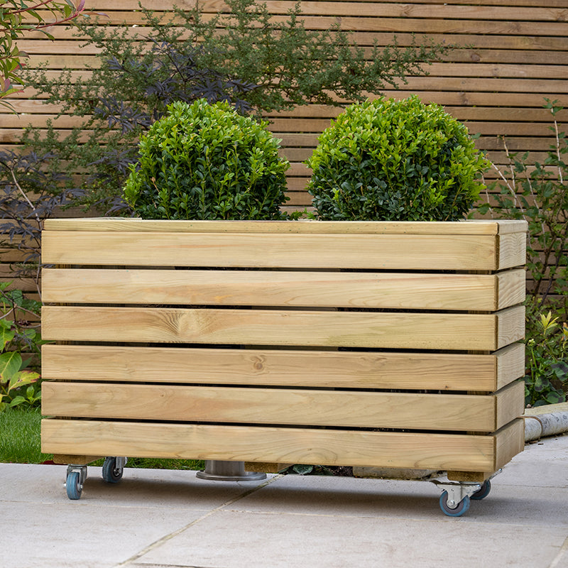 A Large wooden planter with wheels and shrubs