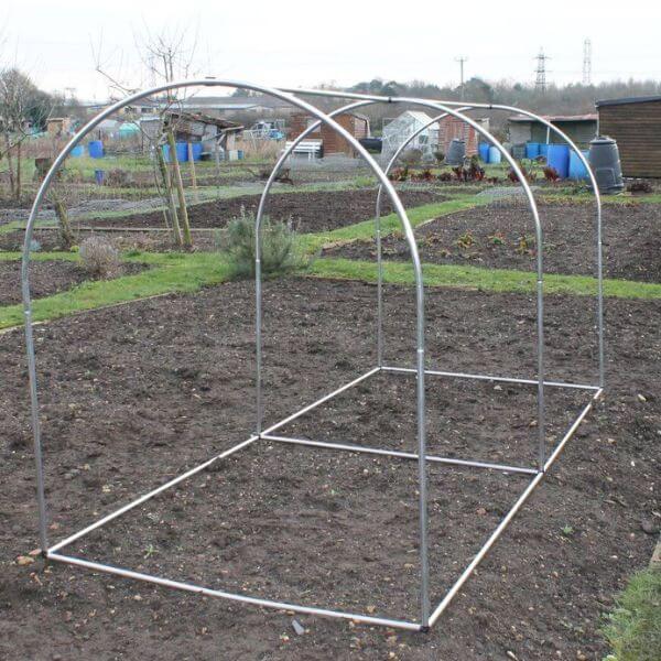 Metal greenhouse frame in a garden setting