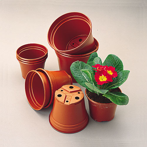 A collection of brown plastic pots in various sizes, including a large pot with a plant inside. The pots have a solid color and a smooth finish.