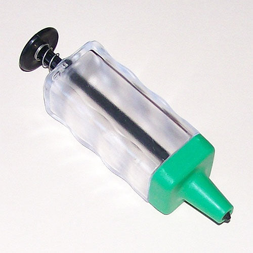 A hand-held Magic Seeder tool with a green plunger and a black top.