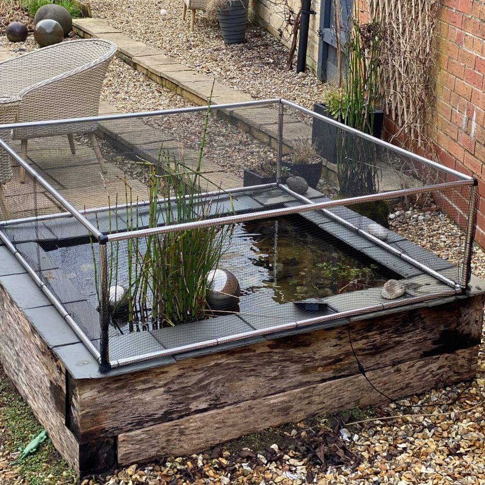 Small pond with a metal cover in a garden setting