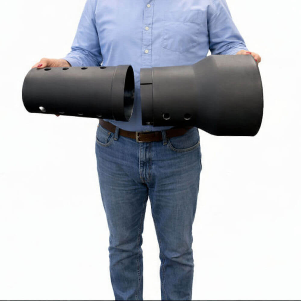 Person holding two large black cylindrical underground composter