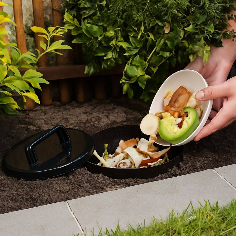Person disposing of food waste into a compostable container outdoors.